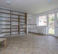 A spacious room in a family house with large windows and a built-in wardrobe.