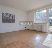 A spacious room in a family house with a ceramic floor and a large window.