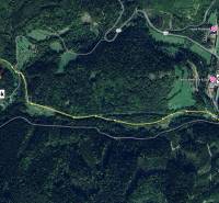 Aerial view of agricultural and forest land in Lazy pod Makytou, showing the road to the plot.