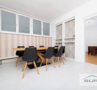 Dining area with a table and chairs, next to an office with a desk, 4-room apartment.