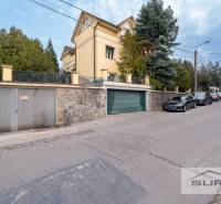 Krčméryho Street in Bratislava - Staré Mesto with a garage entrance and parked cars.