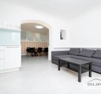 Living room of a 4-room apartment with a kitchenette and a sofa set.