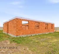 A family house under construction made of bricks with a plot in Veľké Dvorníky.