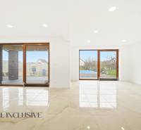 Living room in a family house with large glass doors and a view of the yard.