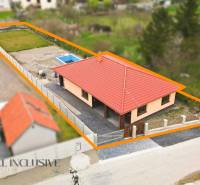 A family house in Horné Mýto with a red roof and a swimming pool in the yard.