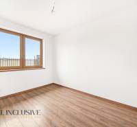 A room in a family house with white walls, a wooden window, and a floor with a wooden decor.