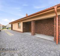 A family house in Horné Mýto with a brick facade and a paved courtyard.