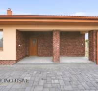 A family house in Horné Mýto with a brick facade and a paved courtyard.