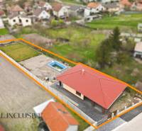 A family house in Horné Mýto with a swimming pool, garden, and red roof.