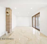 A spacious room in a family house with large windows and a light floor.