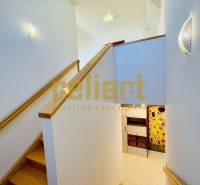 Interior of a family house with a staircase and a wooden decor floor.
