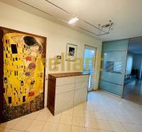 Interior of a family house with a tiled surface and a painting on the wall.