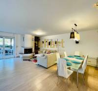 Interior of a family house with a fireplace, wooden decor flooring, and a dining table.