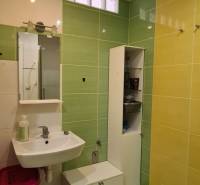 A bathroom with a sink, bathroom furniture, and colorful tiles in a 3-room apartment.