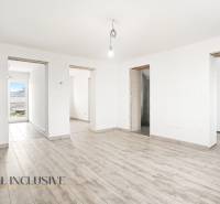 The interior of a family house with a wooden decor floor and clean white walls.