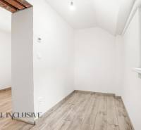 White room with wood-patterned flooring in a family house.