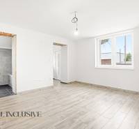 The interior of a family house with a wooden decor floor and a large window.