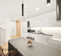 A kitchen in a 4-room apartment with subtle wall decorations and soft colors.