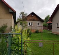 A family house in Blatnica, Blatnica, with a front garden and neighboring buildings.