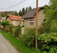 A family house on Blatnica Street in Blatnica, surrounded by greenery and a fence.