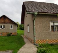 A family house in Blatnica on Blatnica Street with two buildings and a green lawn.