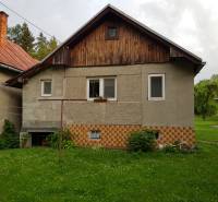 A family house on Blatnica Street in Blatnica with a lawn and wooden details.