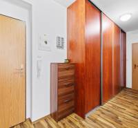 Interior of a 2-room apartment with a wood-decor floor and a built-in wardrobe.