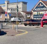 A street in the city with cars, a bike lane, and a Tool Rental building, 1-bedroom apartment not mentioned.
