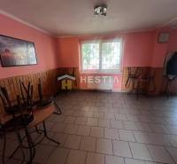 Gastro premises with tiles, pink walls, and stacked furniture.