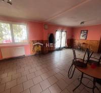 Gastro premises with a brick floor, wooden decor on the walls, and tables.