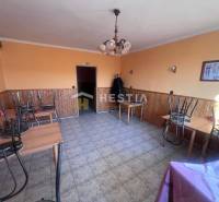 Orange-themed gastro spaces with tiled floors, tables with chairs turned upside down.