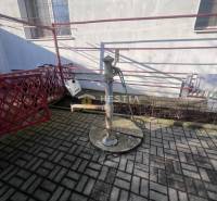 Water pump on concrete paving near the building in the Gastro premises in Senica.