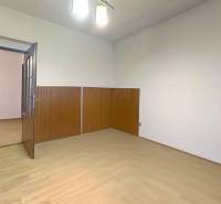 A room in a family house with a floor featuring a wood decor and wooden wall paneling.