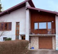 A family house in Vyšná Šebastová with a balcony, wooden cladding, and a garage.