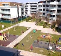 Apartment buildings with a children's playground on Orechova Street in Dunajská Lužná.