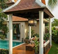 Villa in Pattaya with a pool and a terrace with a wood-patterned floor.