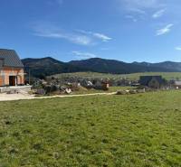 Building a house on a plot of land in Borie, Stránske, with a view of the surrounding mountains.