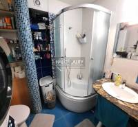 A bathroom in a 3-room apartment with a modern shower and a washing machine.