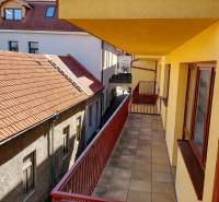 A balcony of a 2-room apartment on Kostolné námestie in Kežmarok with a view of the rooftops.