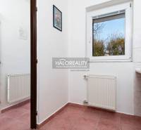 A corridor with a radiator, ceramic tiles, and a window with a view, hotels and guesthouses.