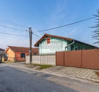 Street with family houses and a car in Veľký Meder, Hotels and guesthouses in the vicinity.