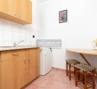 Kitchen corner in hotels and guesthouses with wooden decor and a small table.