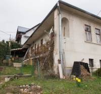 A family house in Kostoľany nad Hornádom with a front garden and wooden elements.