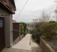 The access path to the family house in Kostoľany nad Hornádom, enclosed by a wooden fence.