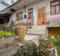 A family house in Kostoľany nad Hornádom with flowers, a terrace, and stairs to the garden.