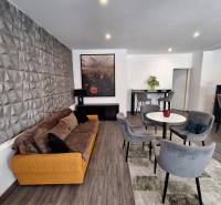 Living room in a family house with a comfortable sofa and dining chairs.