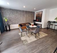 Living room with armchairs and a sofa in a family house, decorative wall and bar corner.