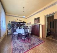 A gently tuned dining room in a family house with a wooden decor floor.
