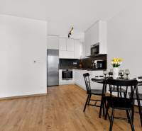 A kitchen with a dining table in a 2-room apartment, floor with a wooden decor.