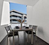 The balcony of a 2-room apartment on Orechova Street in Dunajska Luzna with an outdoor table and chairs.